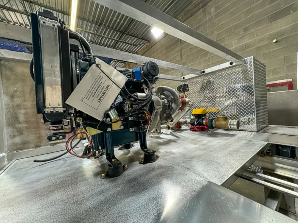 Diamond-plate body and step detail in production, photo 158 of 303.